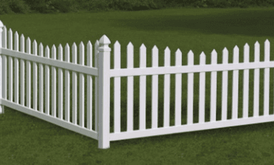 White picket fence in a grassy yard.