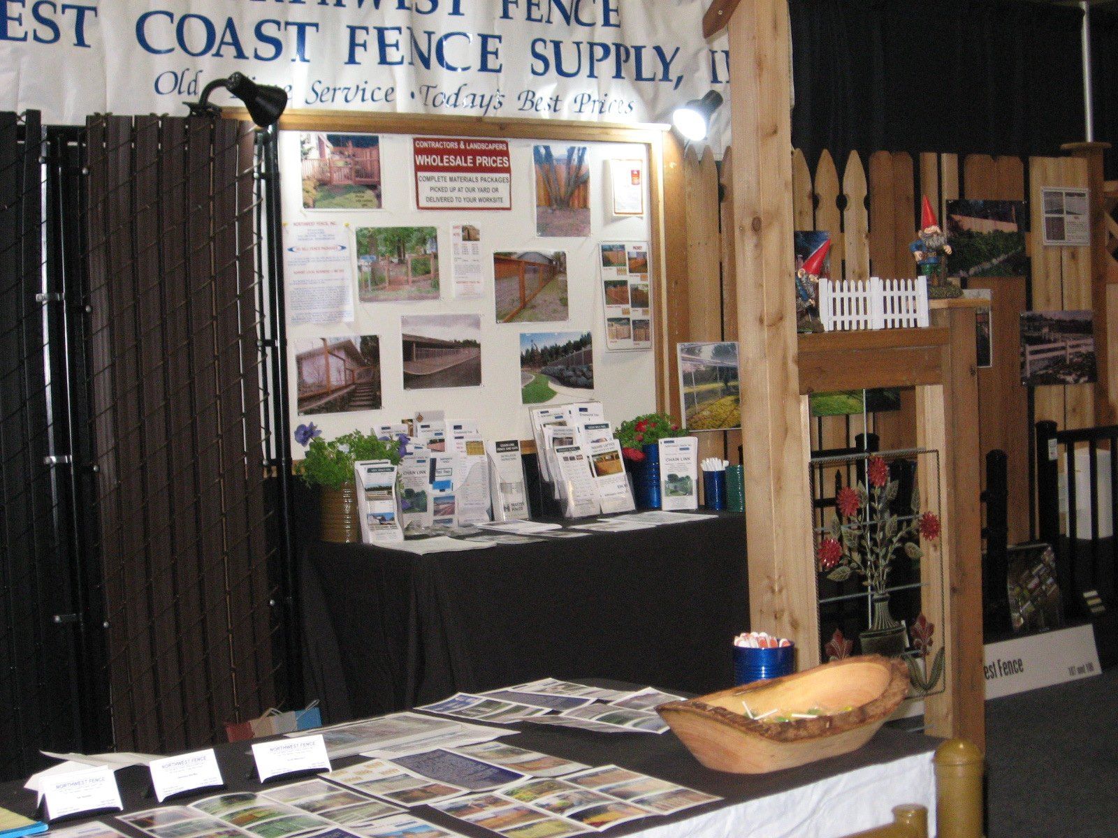 Trade show booth for West Coast Fence Supply with fence samples and promotional materials.
