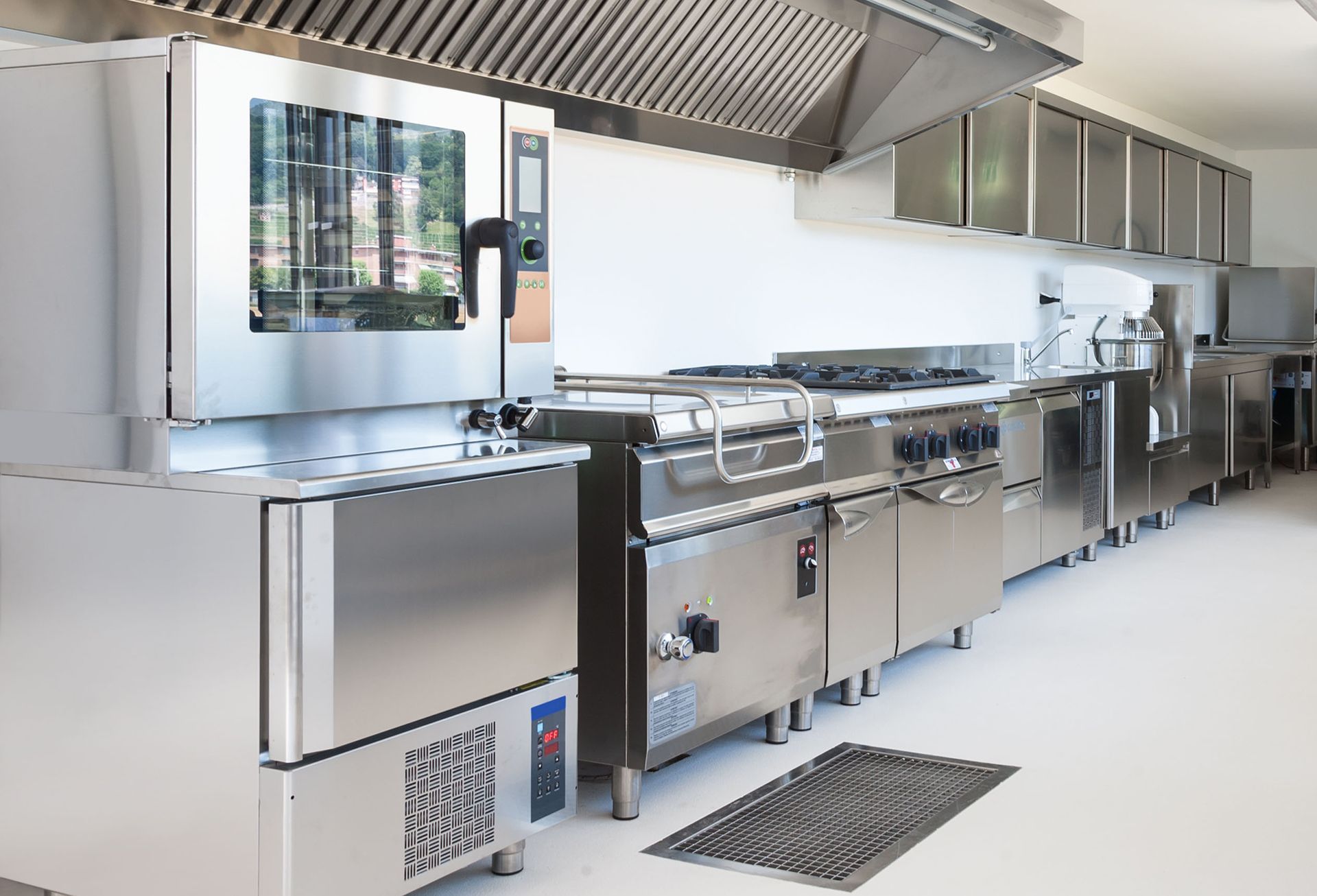 a kitchen with stainless steel appliances and a rug on the floor