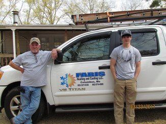Faris Heating & Cooling staff standing with company van