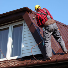 Contractor repairing roof
