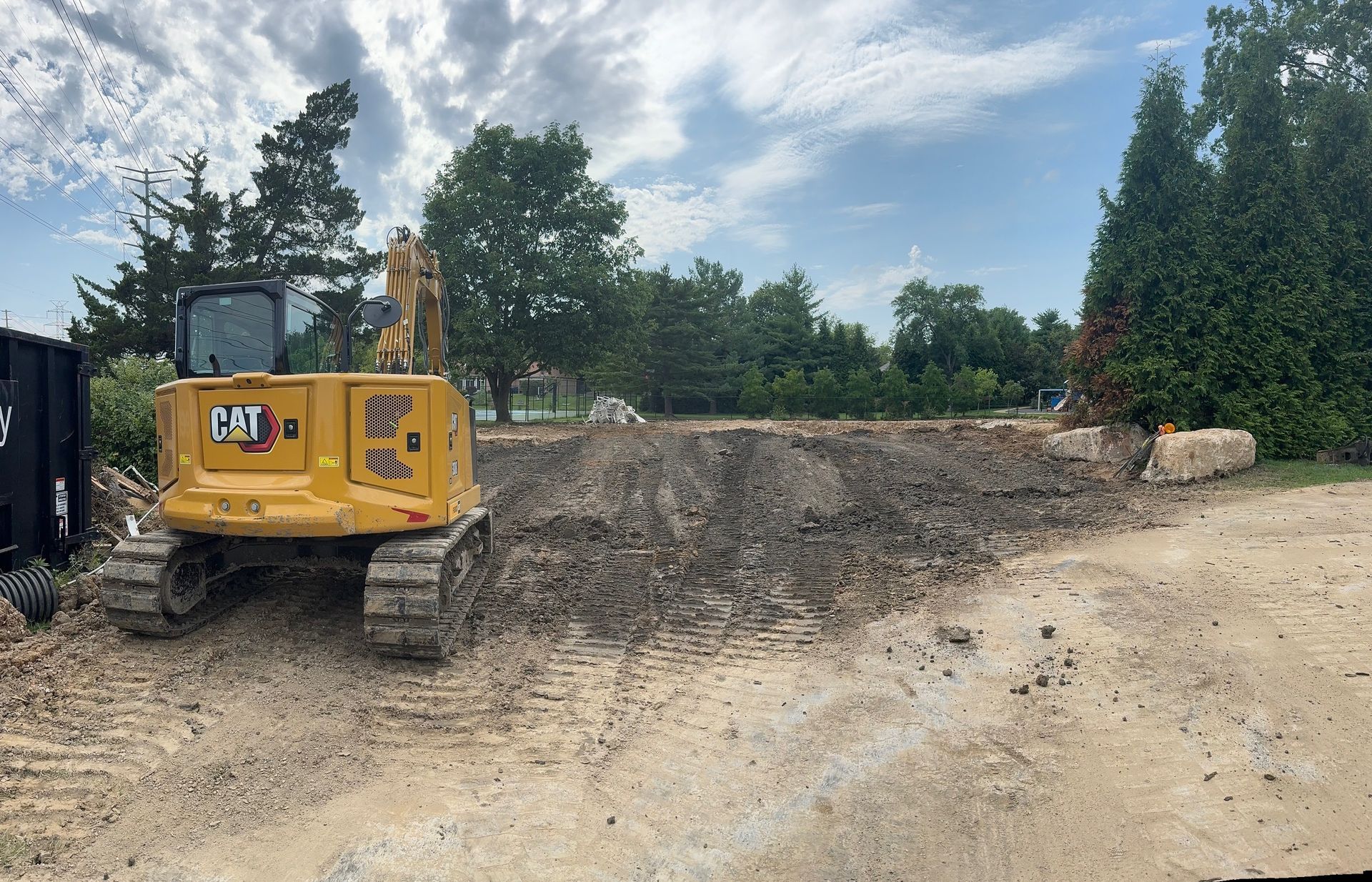 A bulldozer is sitting on top of a swimming pool.