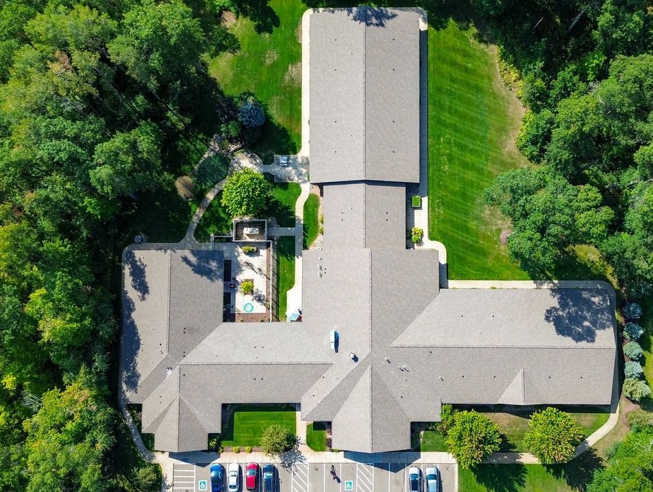 An aerial view of a large building surrounded by trees.