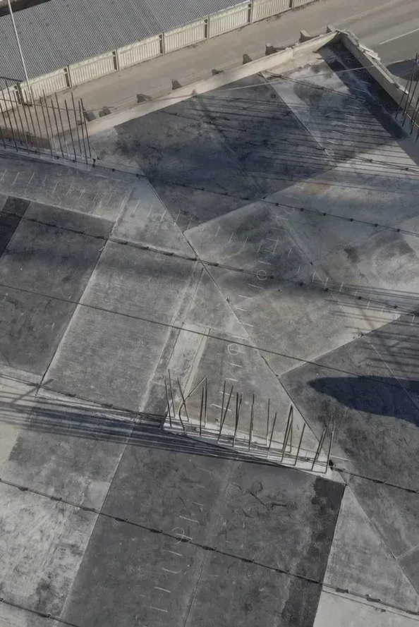 An aerial view of a concrete floor with a geometric pattern.