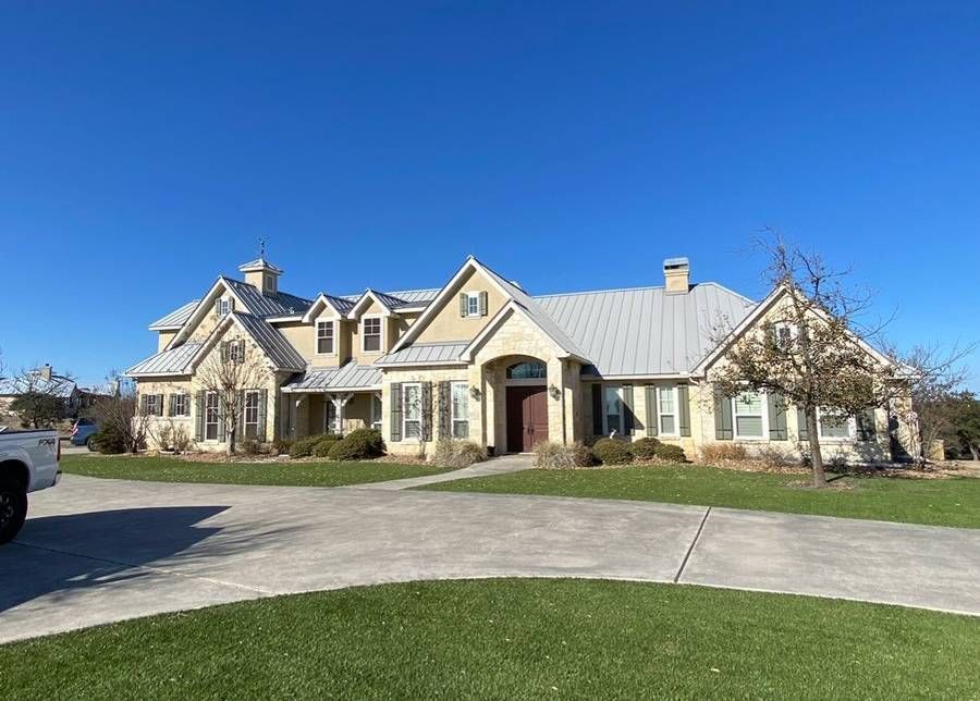 A large house with a white truck parked in front of it