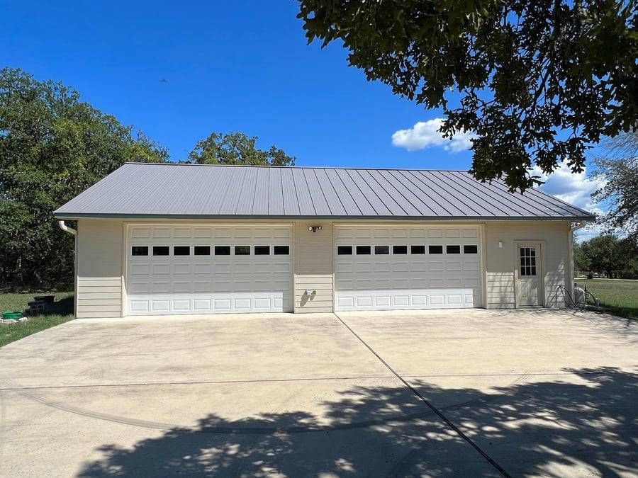 A large white garage with a metal roof