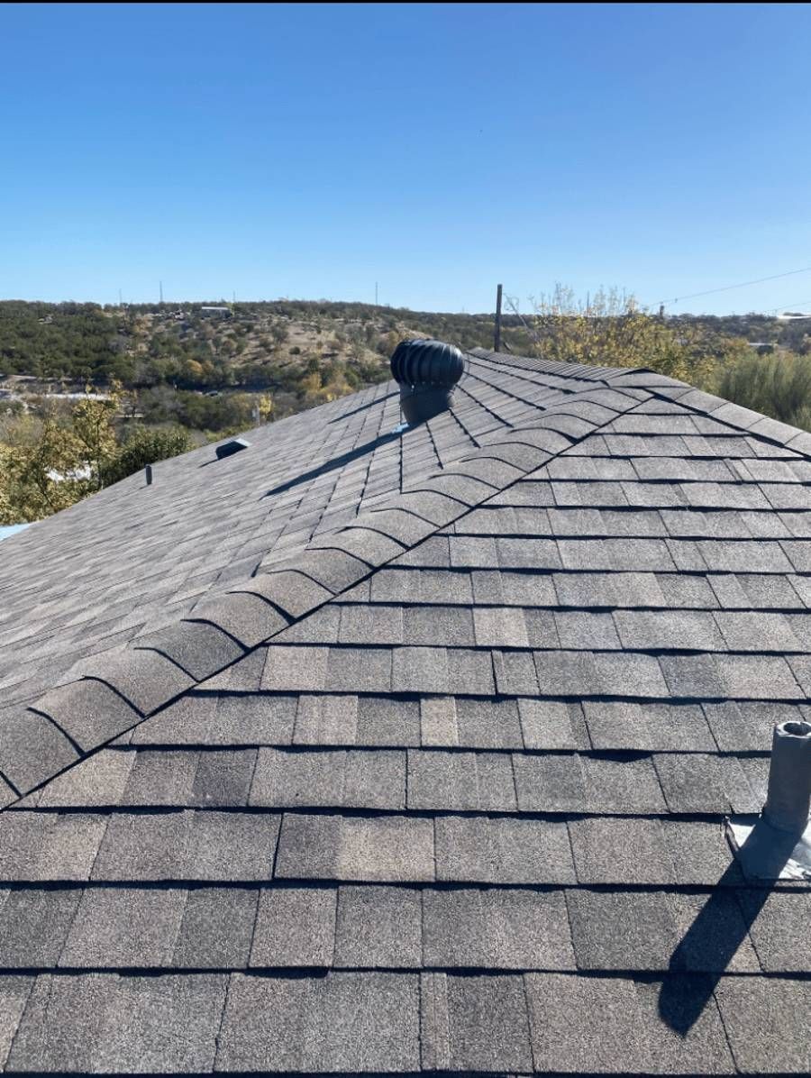 A close-up of a roof with a blue sky in the background