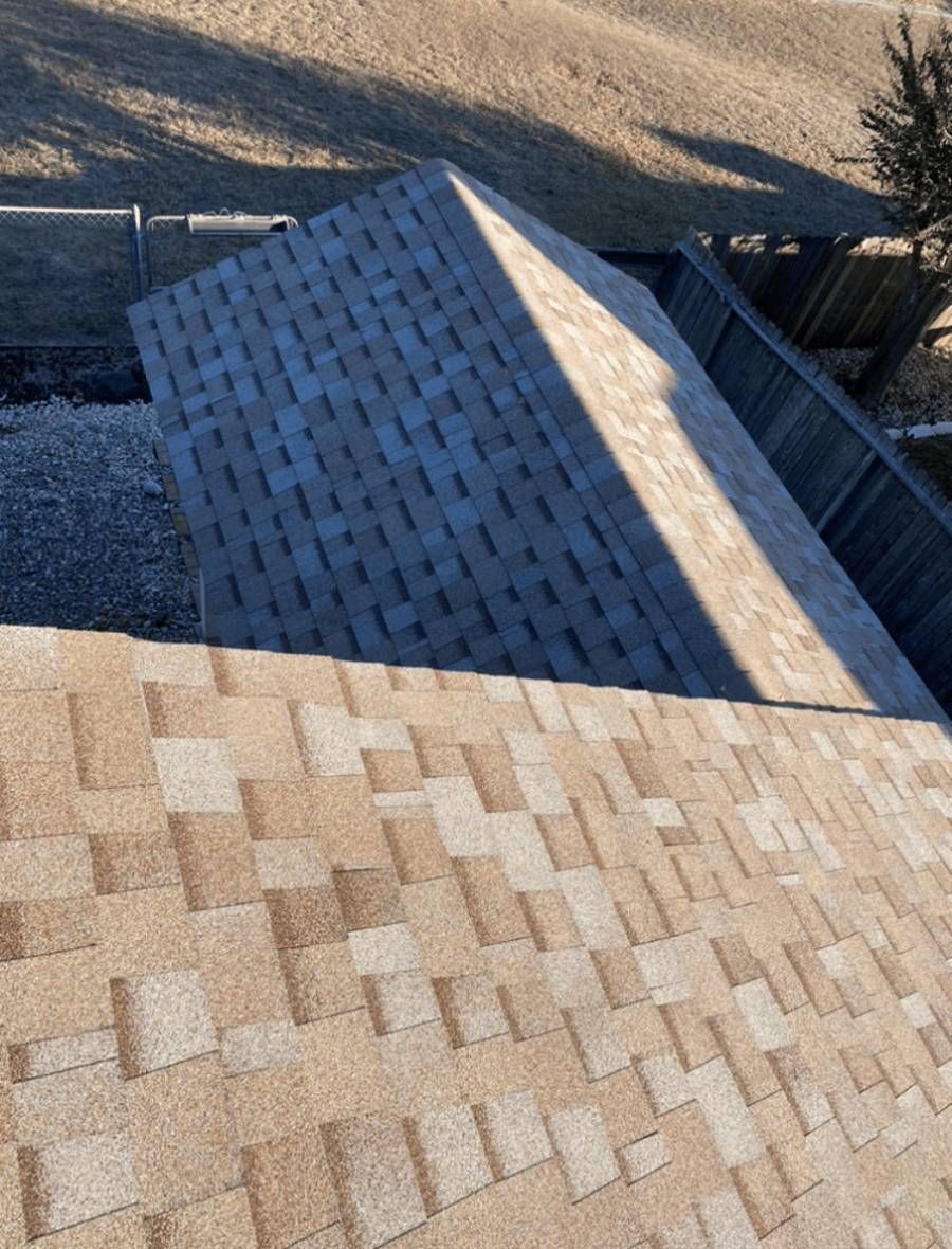 A close-up of a roof with a blue sky in the background