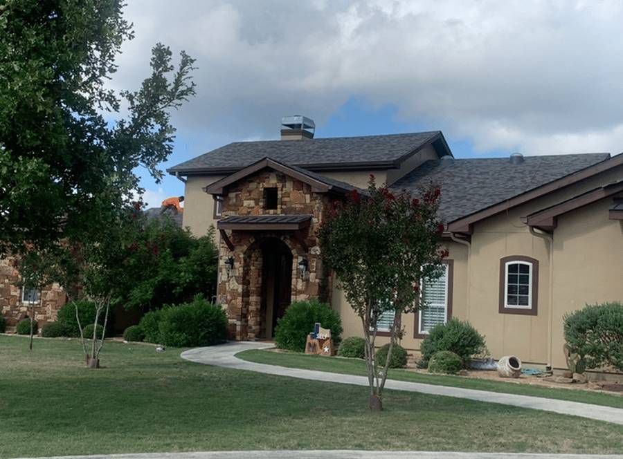 A large house with a walkway leading to it