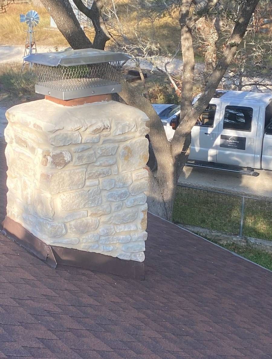 A chimney is sitting on top of a roof next to a truck