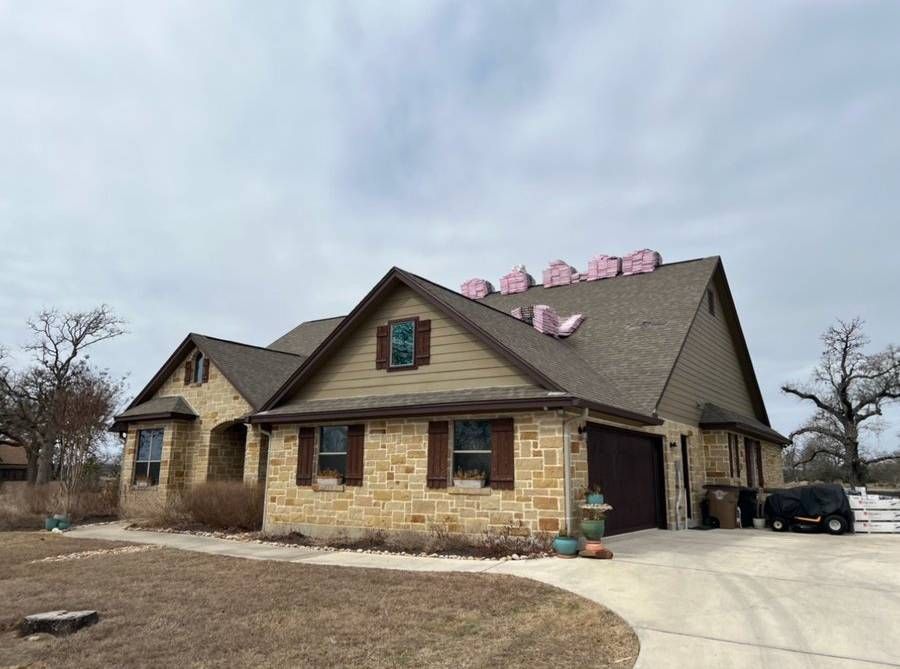A large house with a roof that is being installed