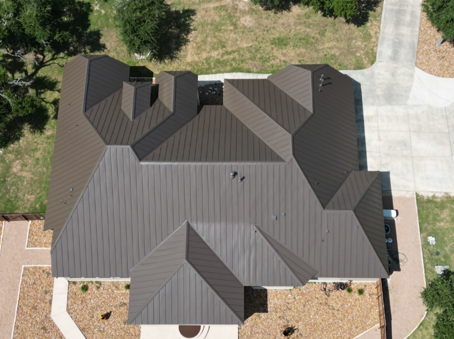 An aerial view of a house with a brown metal roof