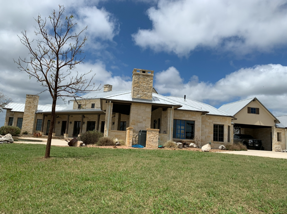 A large house with a white metal roof