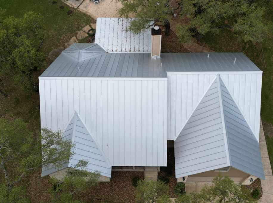 An aerial view of a house with a metal roof