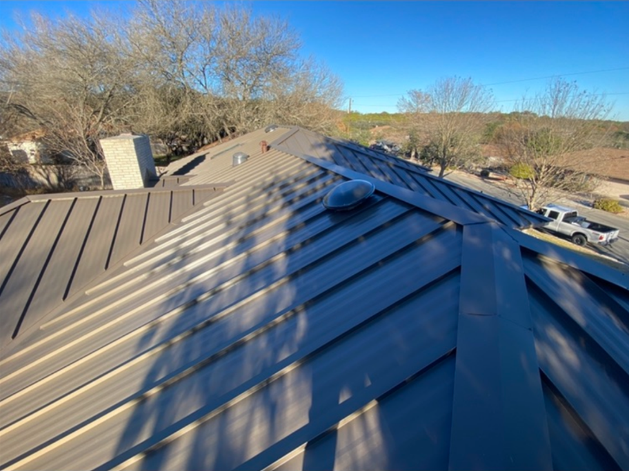 A house with a metal roof and a chimney