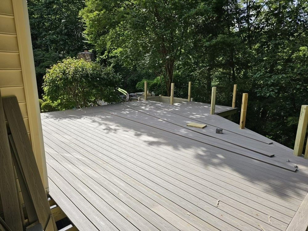 A wooden deck with trees in the background is being built
