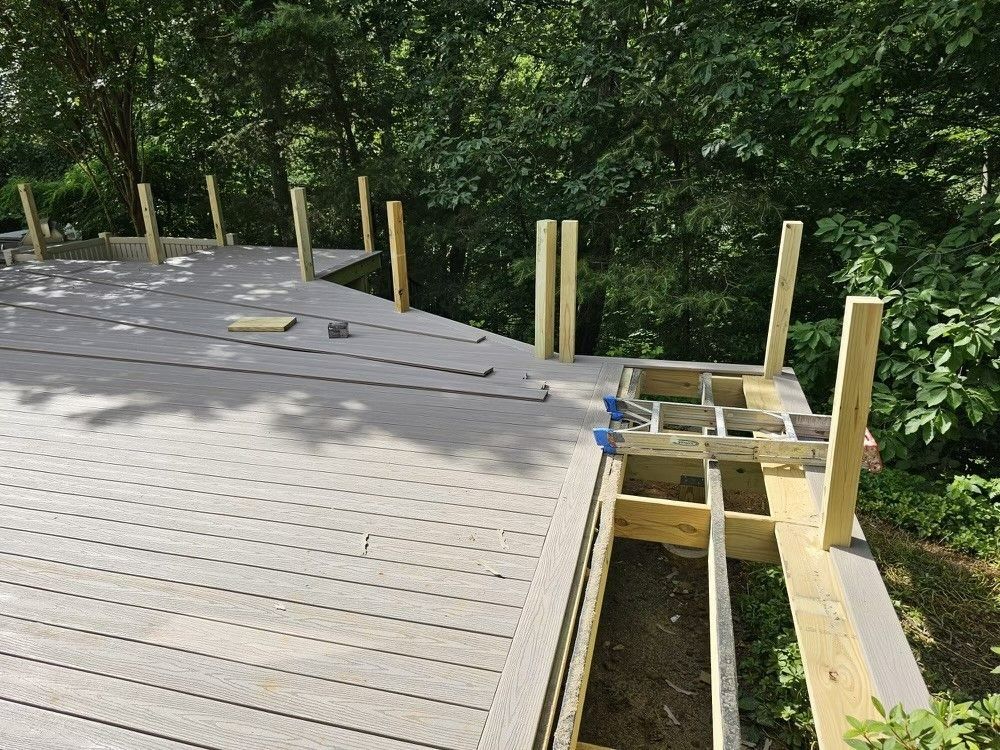 A wooden deck is being built in the woods.