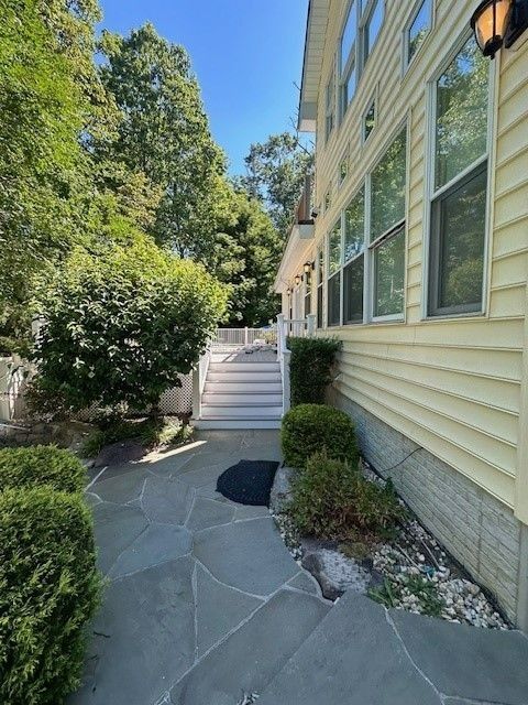 A stone walkway leading to a house with stairs