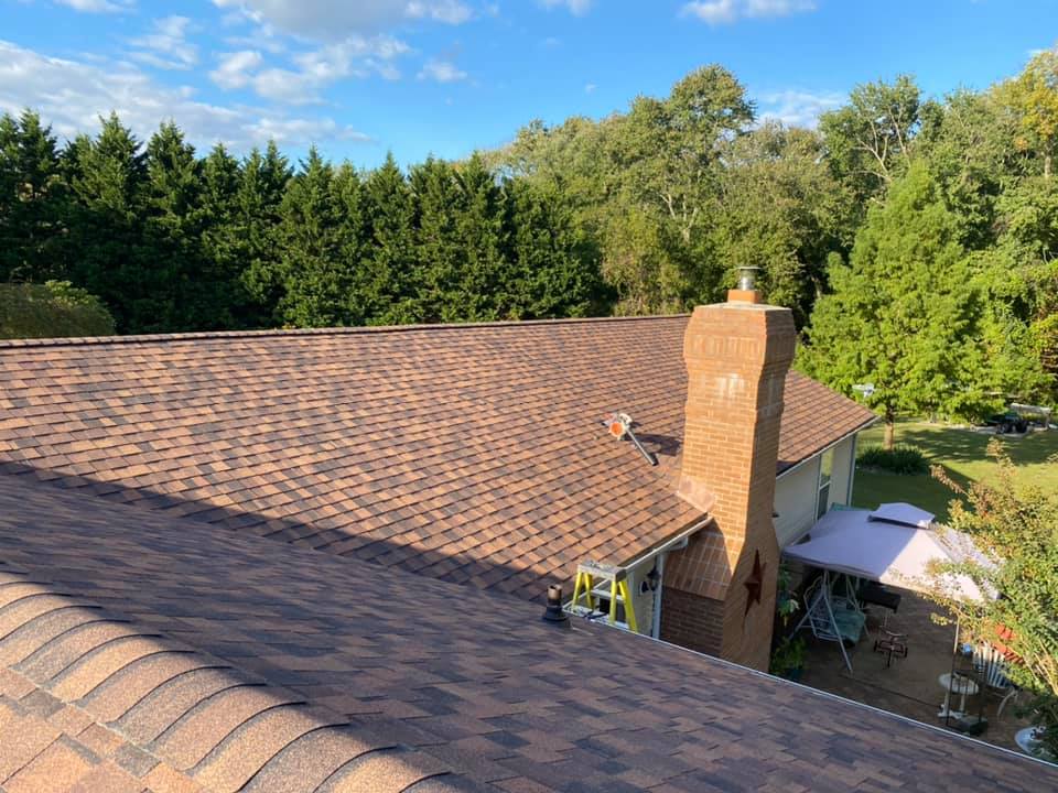An aerial view of a house with a roof and a chimney.