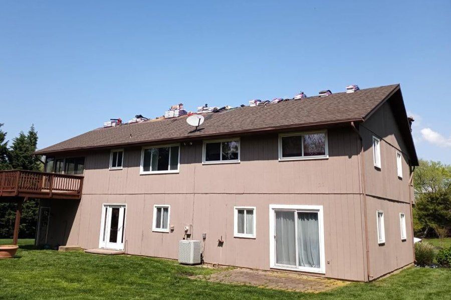 A large house with a lot of windows and a satellite dish on the roof.