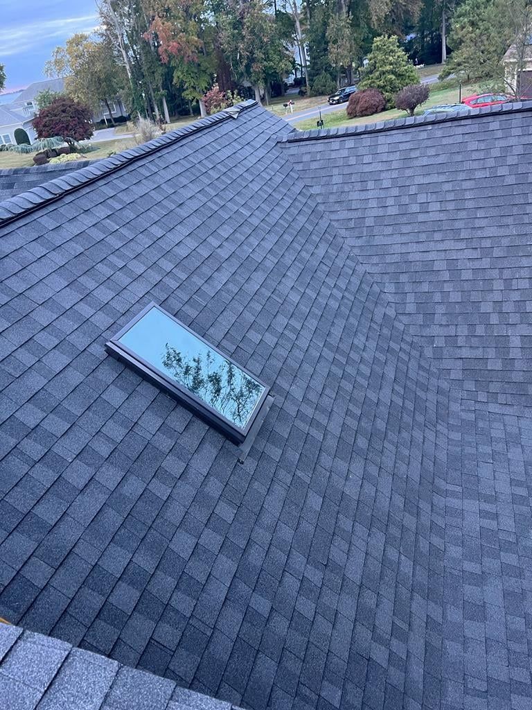 A roof with a skylight on top of it.