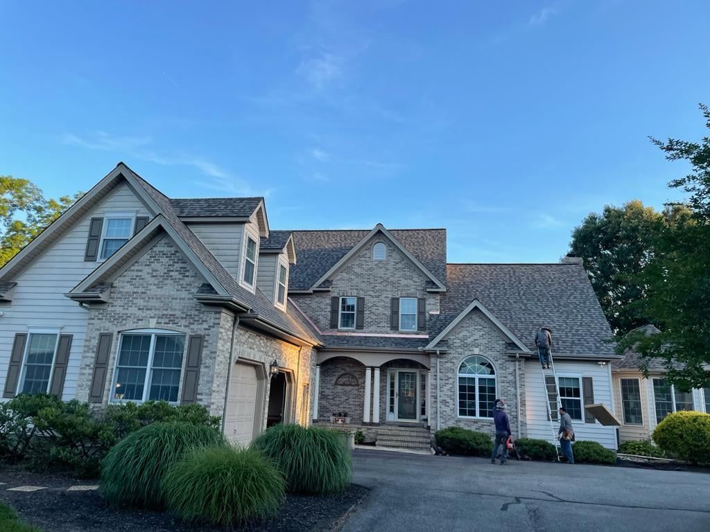 A large house with a lot of windows and a gray roof.