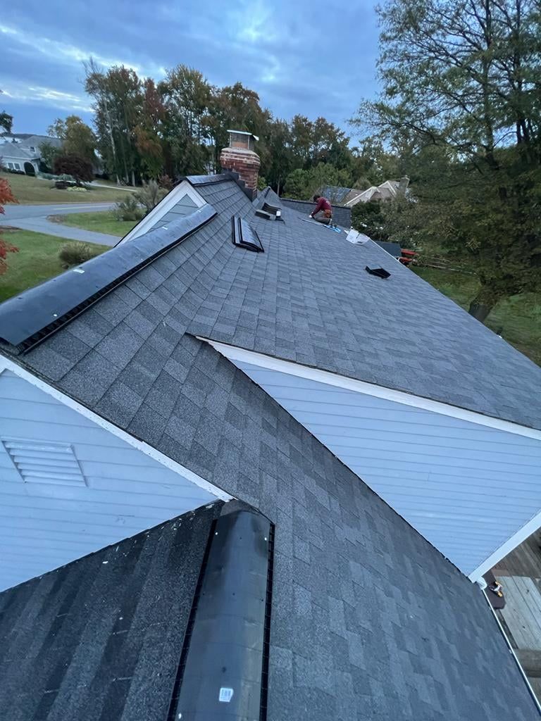 A roof with shingles being installed on a house.