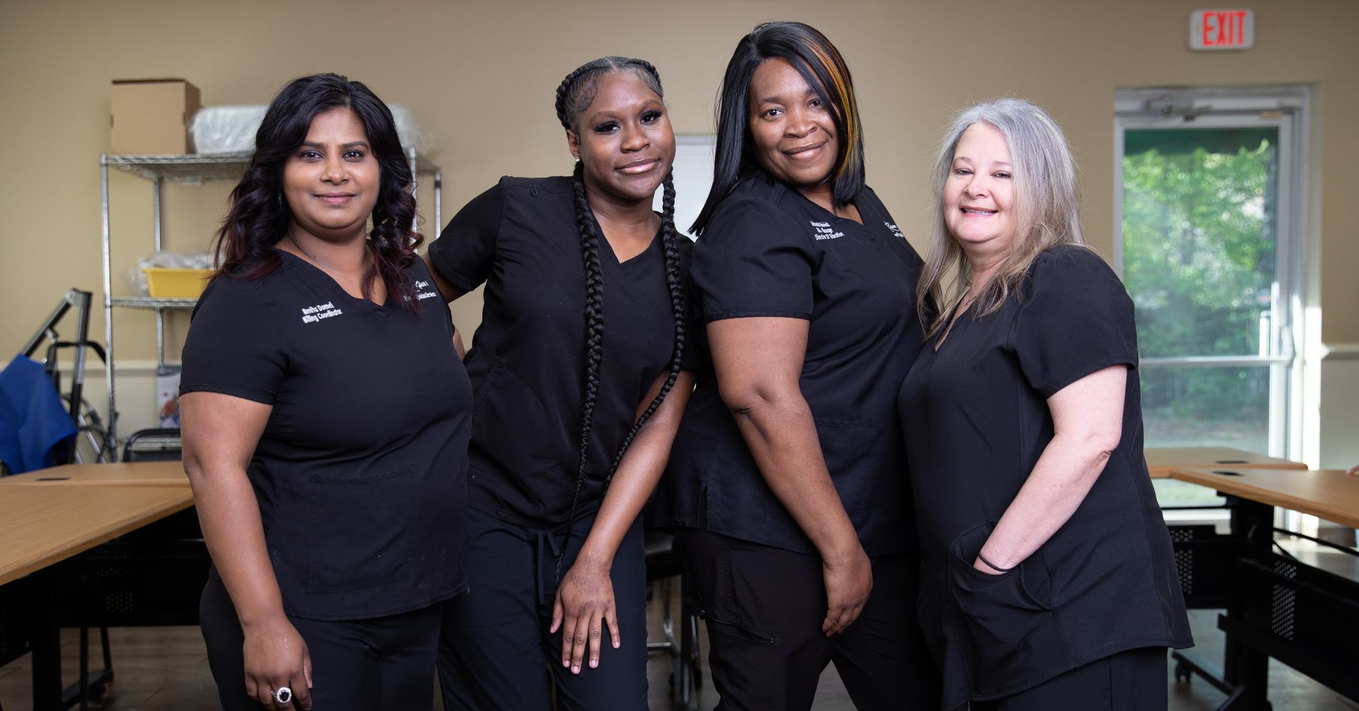 A group of women in scrubs are posing for a picture.