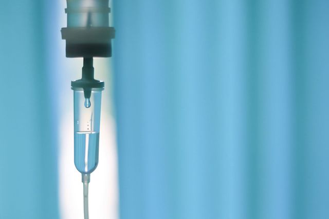 A close up of an iv drip in a hospital room.