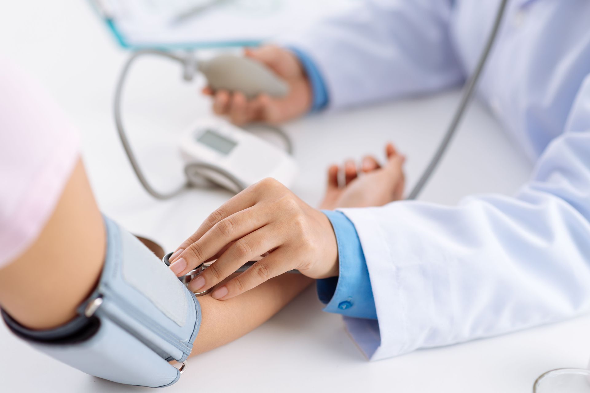 Doctor taking pulse of the patient