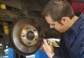 Mechanic repaireing the brakes