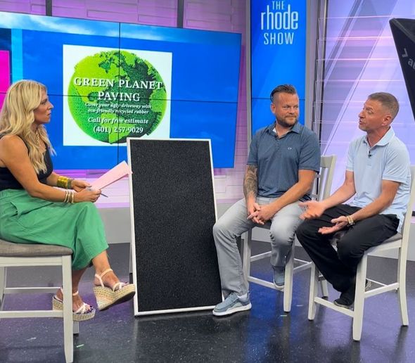 A TV show set featuring a woman interviewing two men about Green Planet Paving.