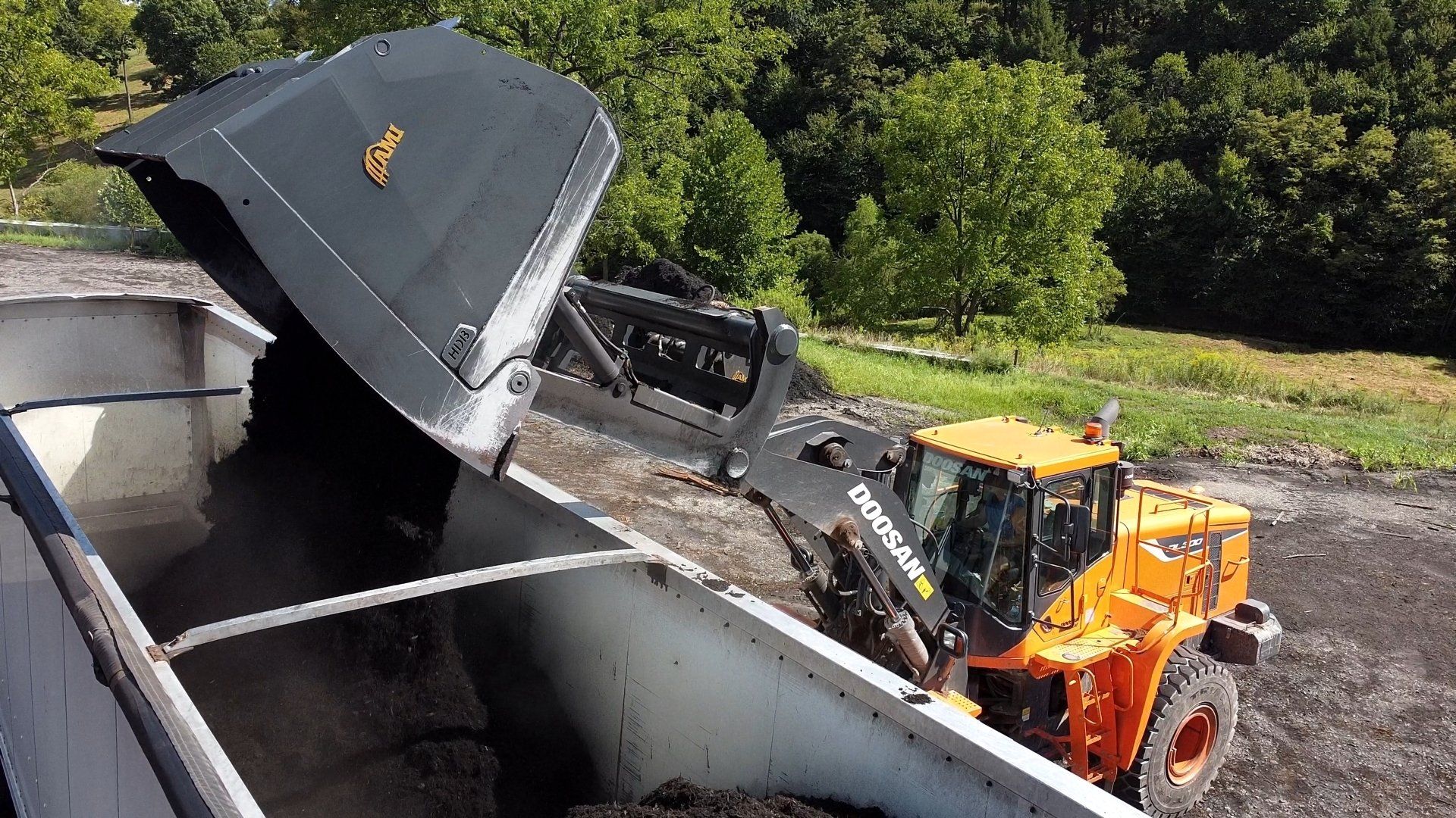Backhoe loading a dump truck