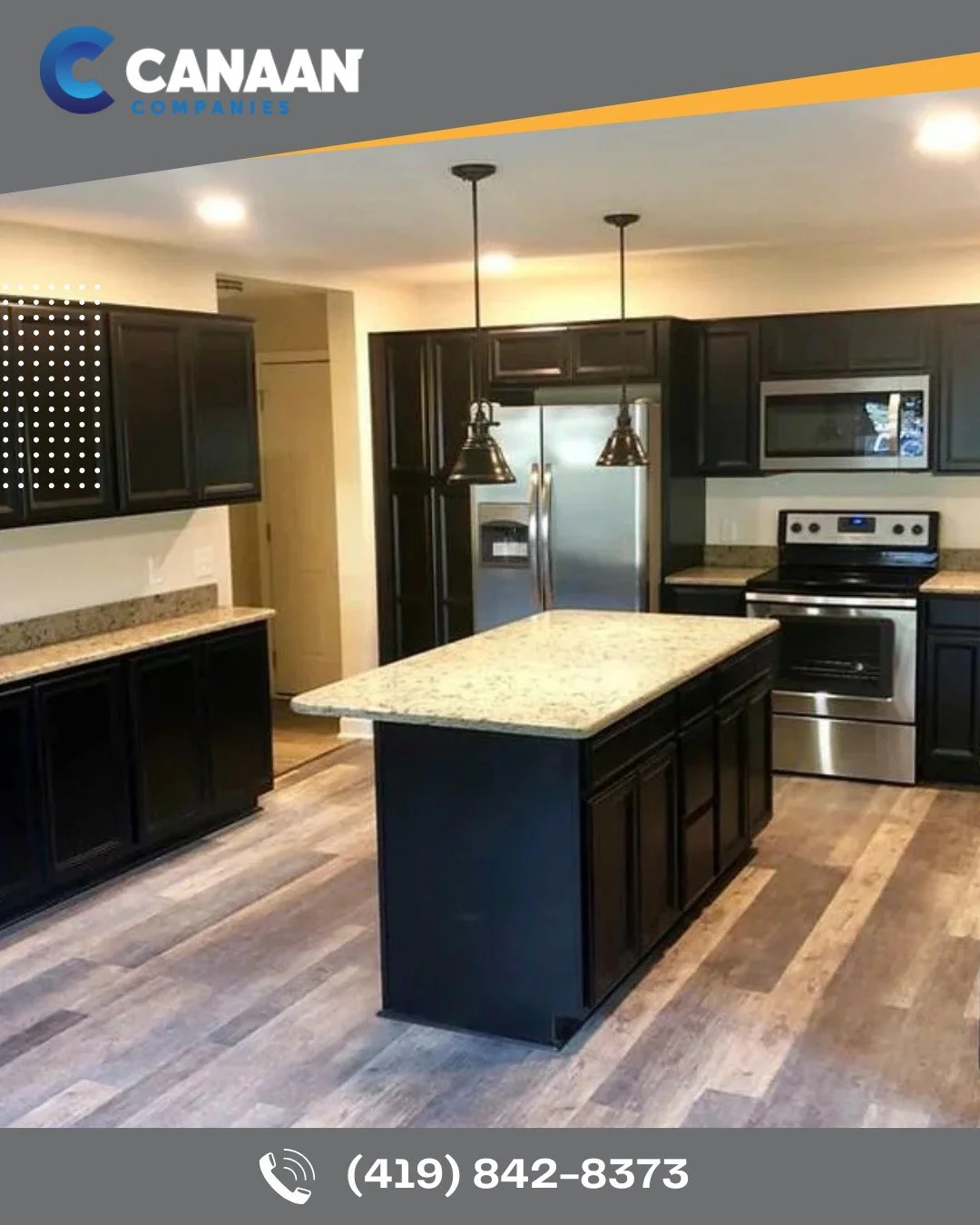 Modern kitchen with black cabinets, stainless steel appliances, and a central island.