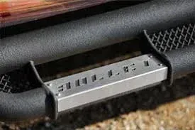 Metal step attached to a black tube, possibly a vehicle's side step.