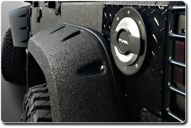 Black textured Jeep fender with fuel door and tire visible.