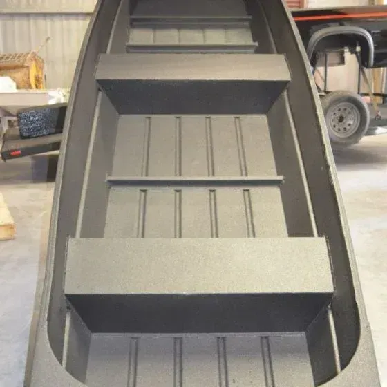 Interior view of a dark gray aluminum jon boat with three bench seats.