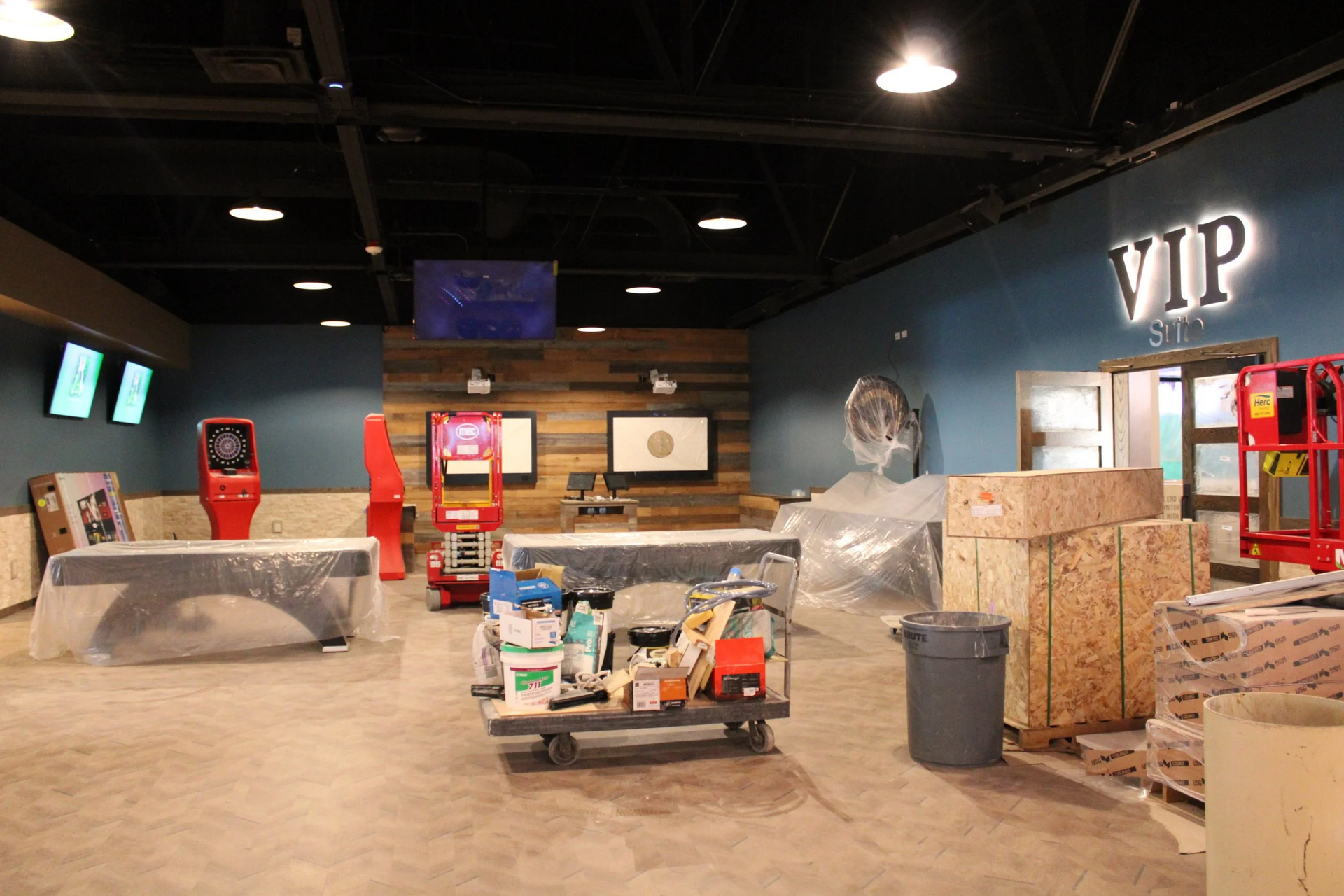 Interior of a VIP area under construction, with tools and materials scattered throughout.
