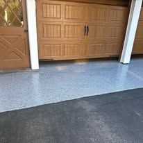 A garage door with a concrete floor in front of it.