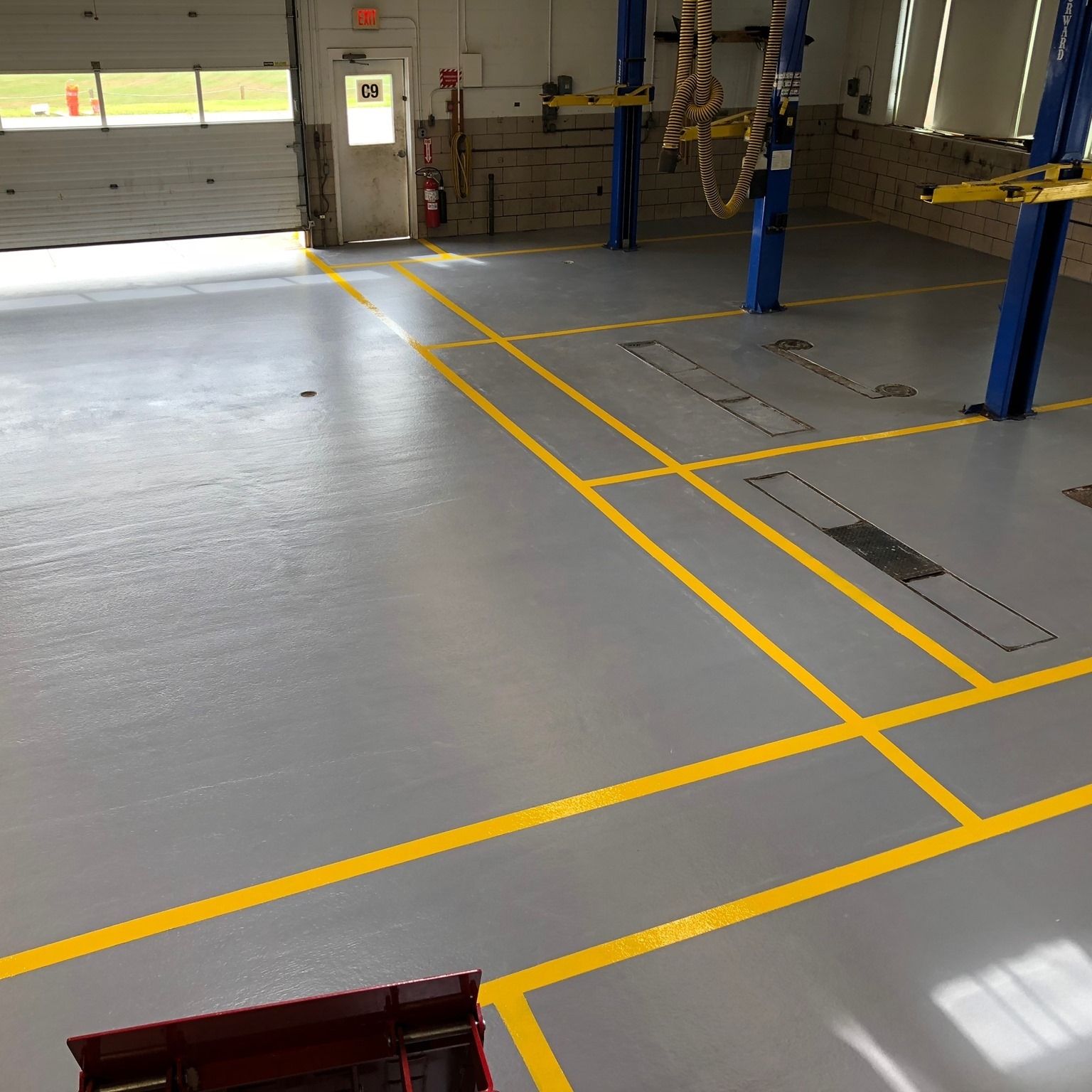 A garage with yellow lines on the floor