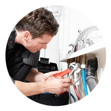 plumber working on a faucet