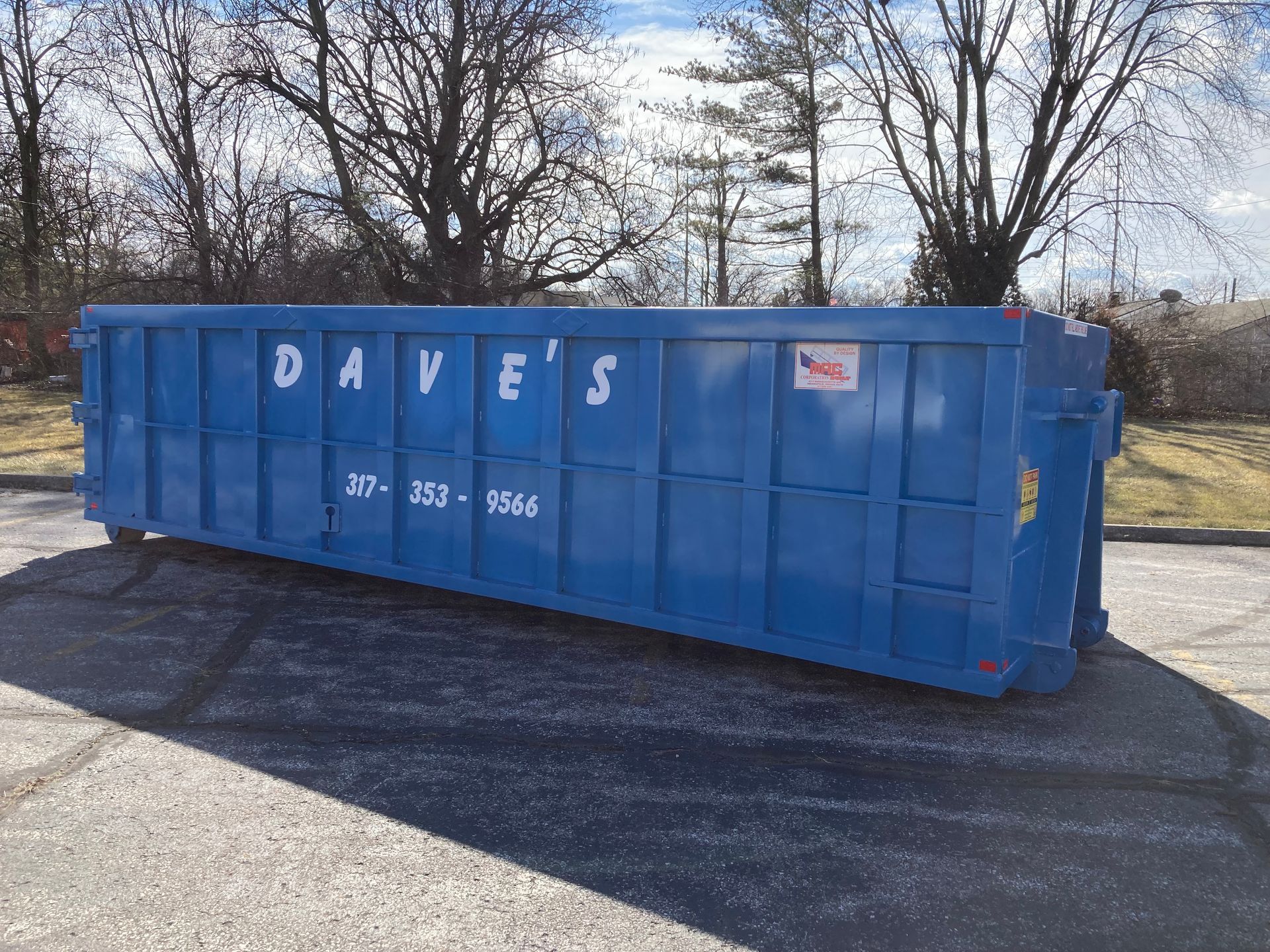 A blue dumpster with dave 's written on it