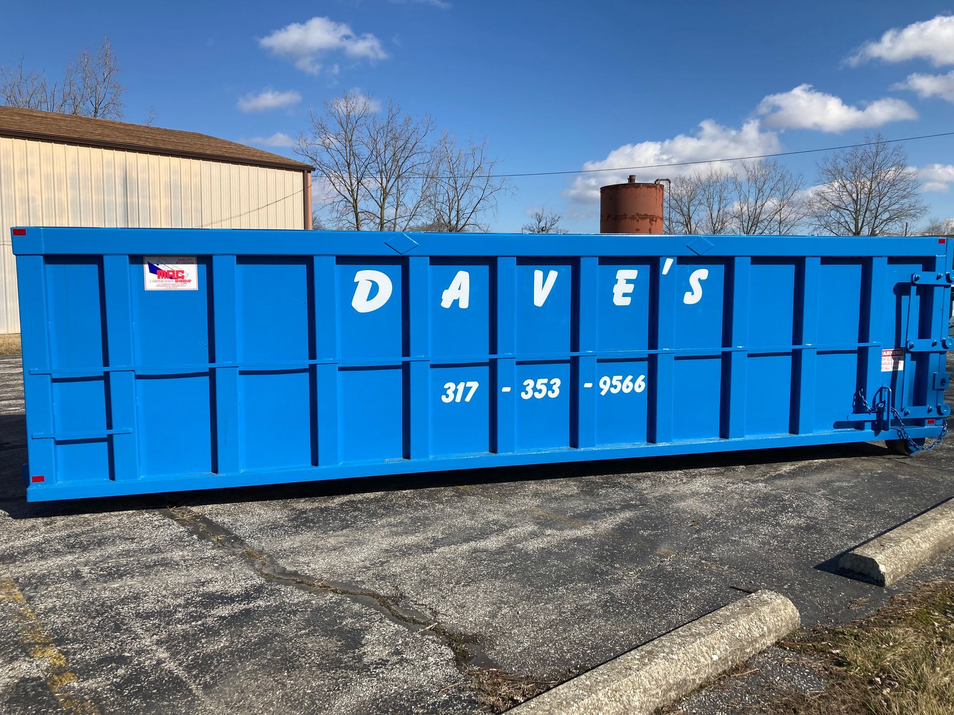 A blue dumpster with the word daves on it
