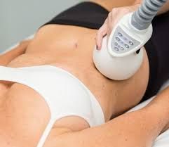 Person receiving body sculpting treatment on stomach with a handheld device.