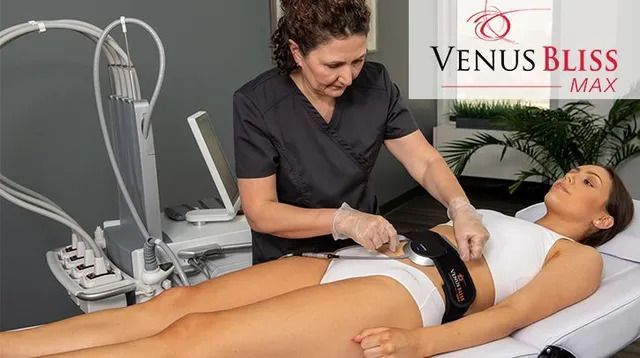 Woman receiving Venus Bliss Max treatment on her abdomen by a technician in a medical spa setting.