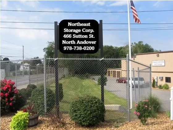 Sign for Northeast Storage Corp. at 465 Sutton St., North Andover, with fenced lot and building behind it