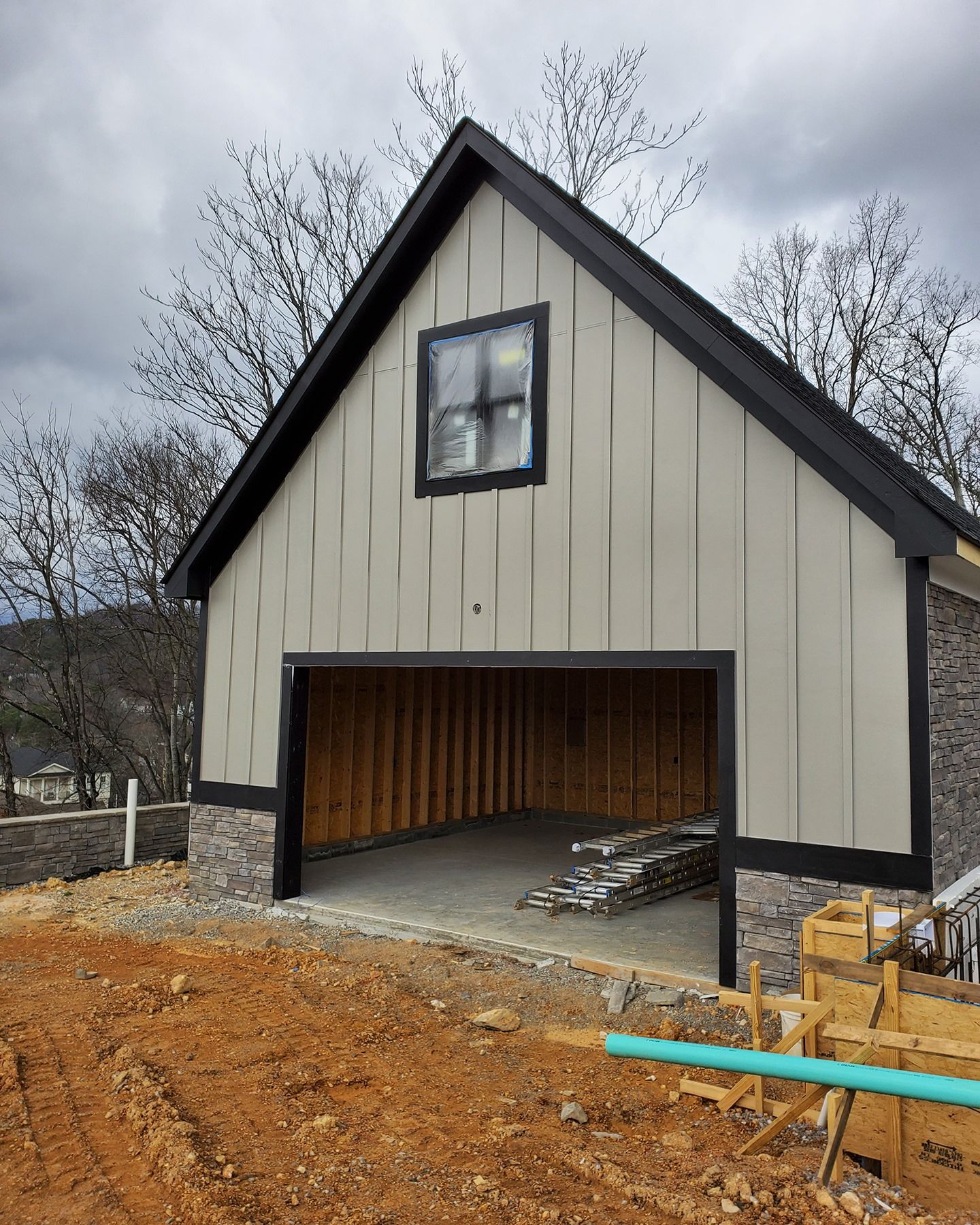 A garage under construction with a window on the top of it