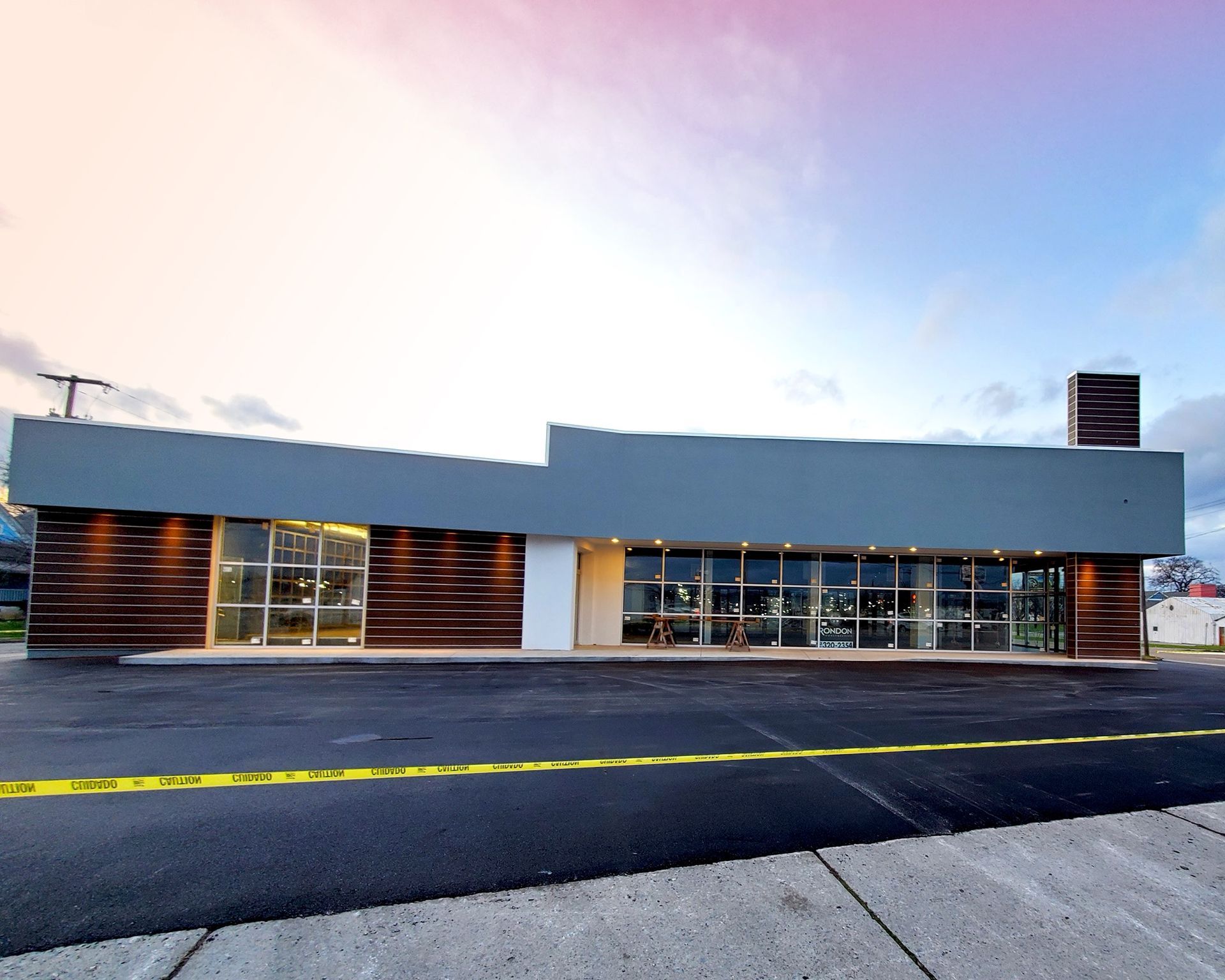 A large building with a lot of windows and a chimney