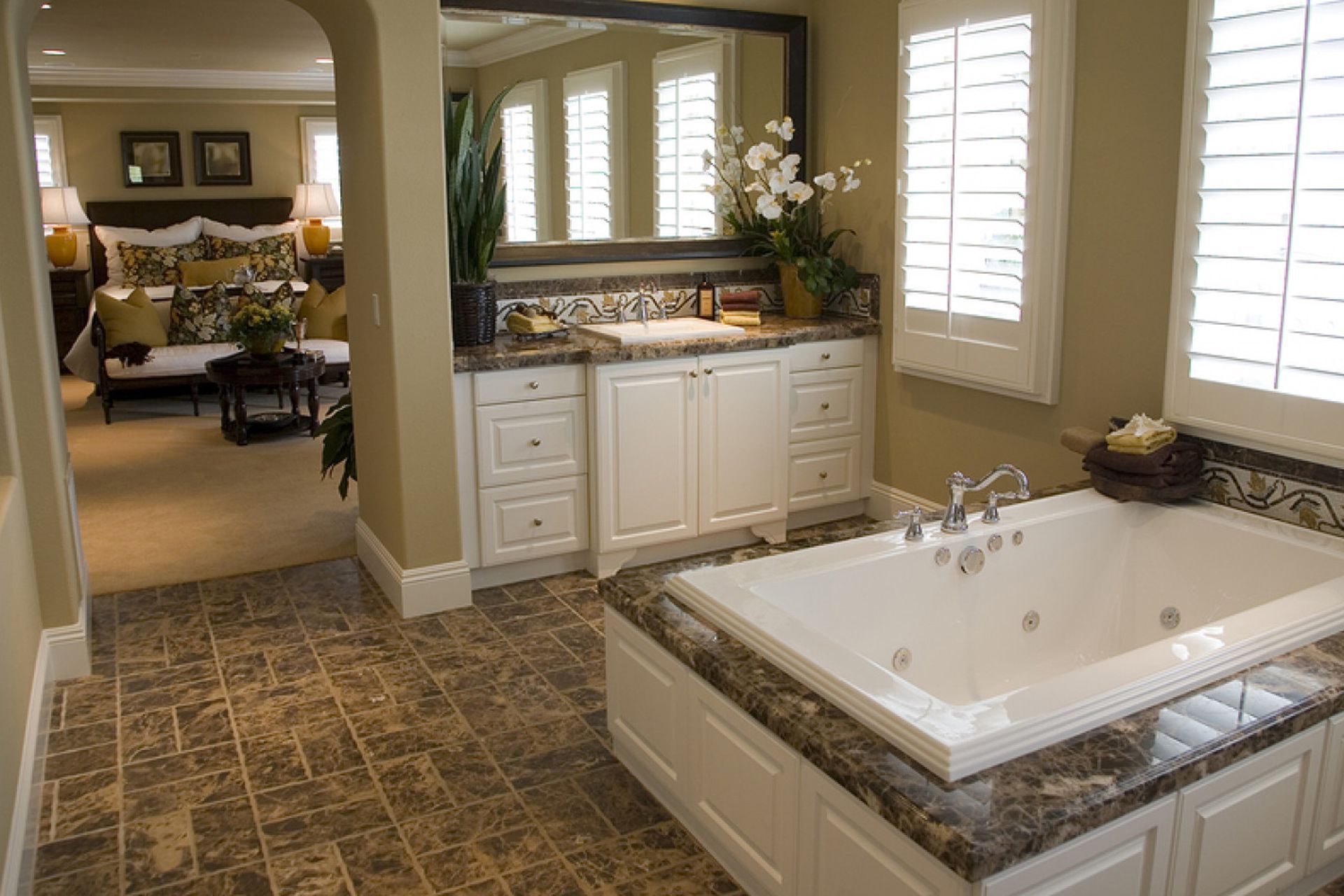 a bathroom with a jacuzzi tub and a large mirror.
