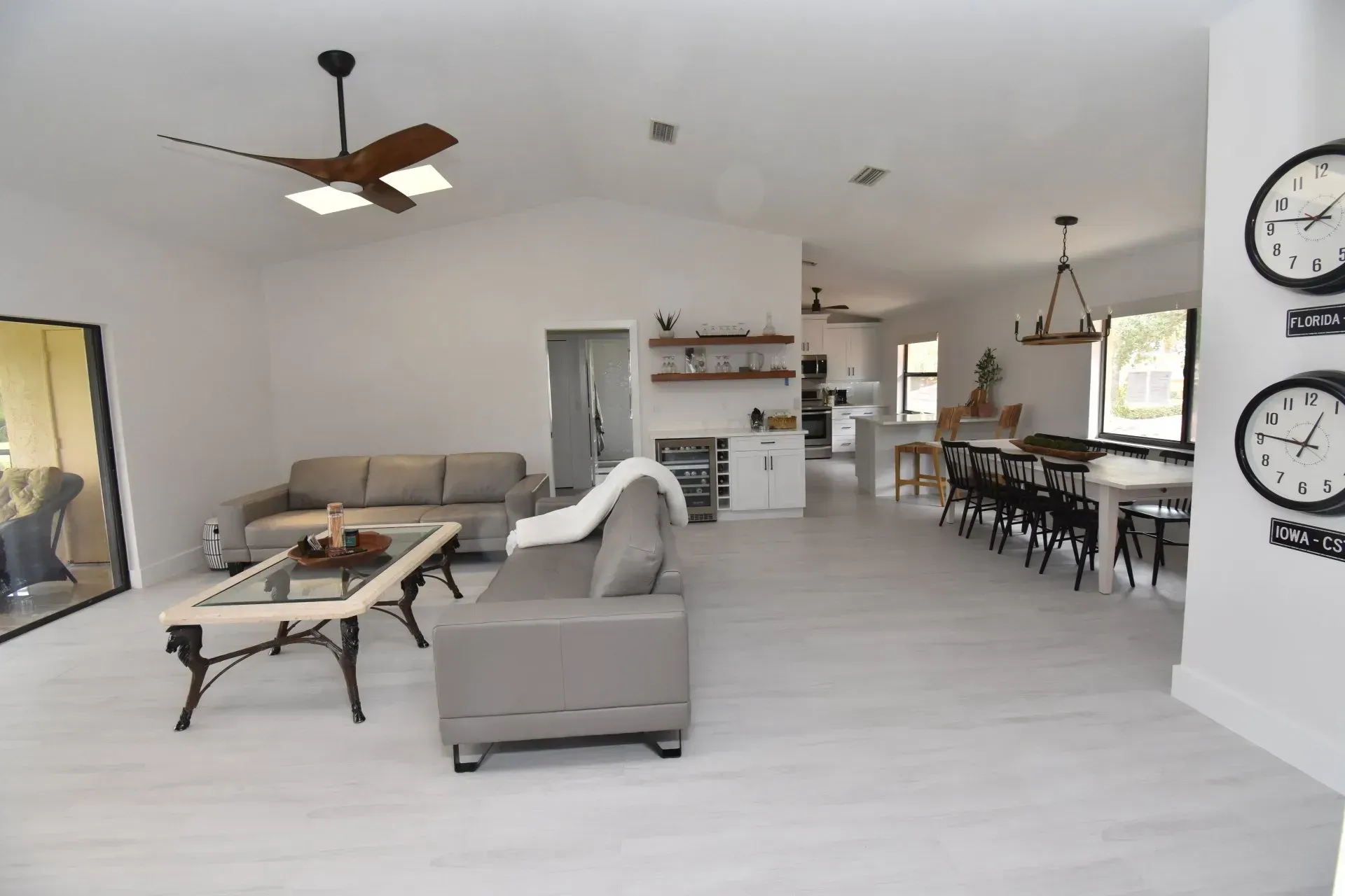 Open-concept living space with white walls, light floors, and neutral-toned furniture.